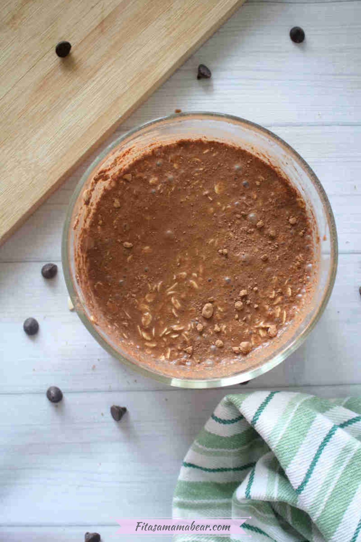 Large bowl with chocolate protein overnight oats with chocolate chips around it.