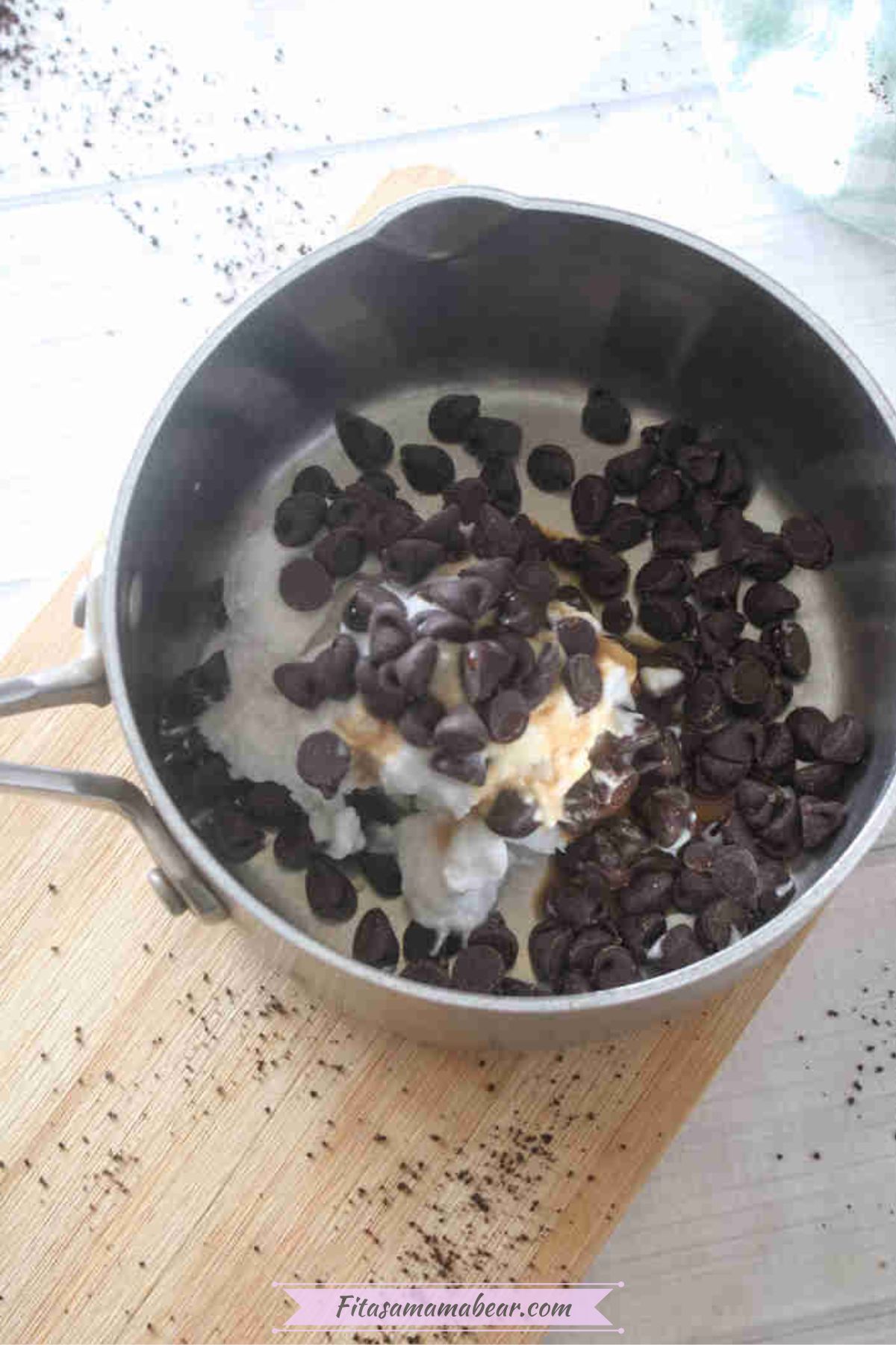 Small pot with coconut milk and chocolate chips in it.