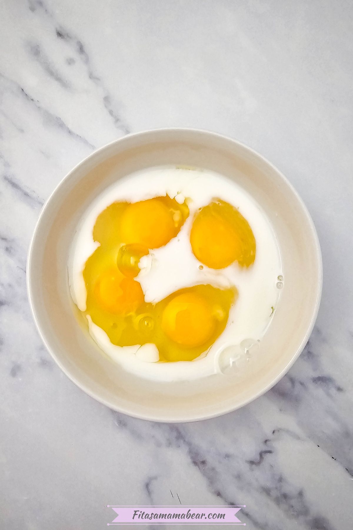 Eggs and dairy-free milk in a white bowl.