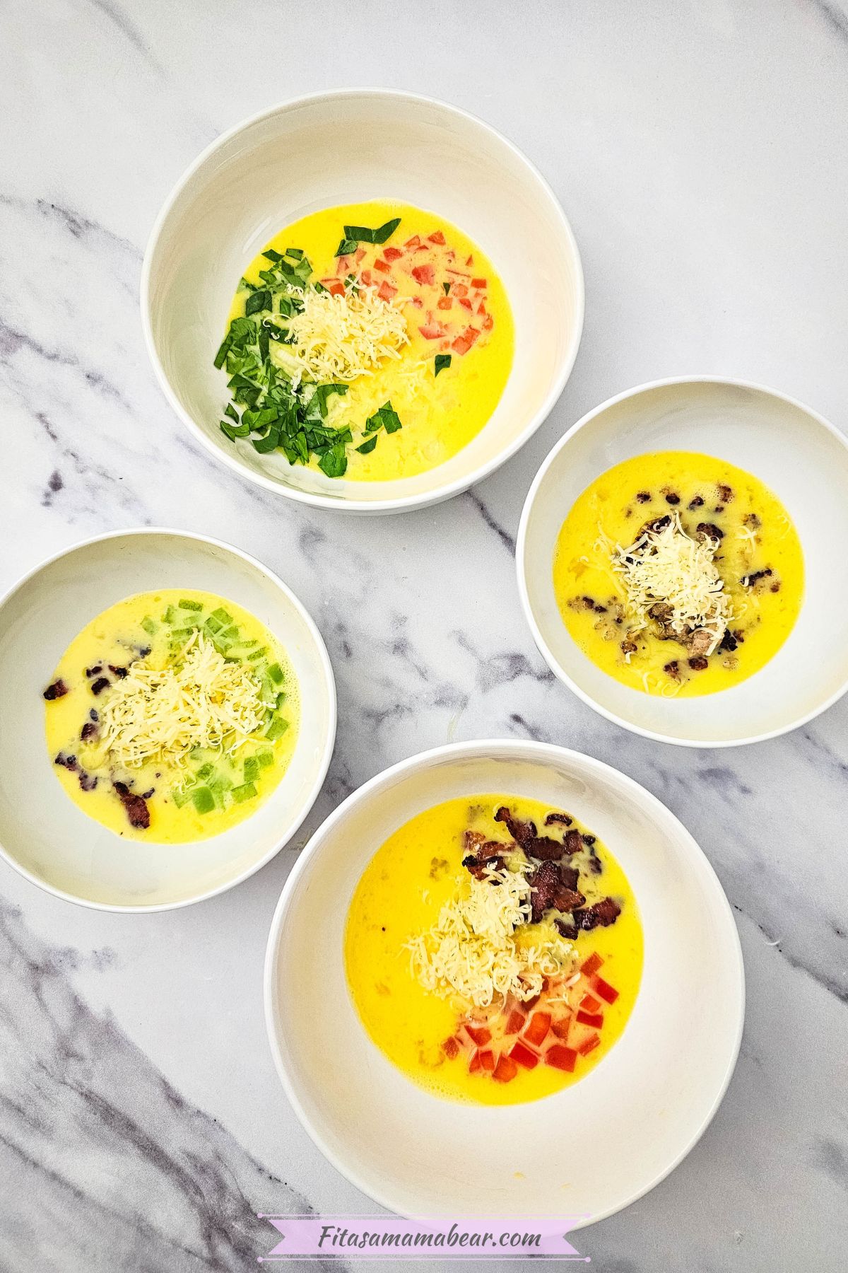 Four bowls of uncooked omelets.