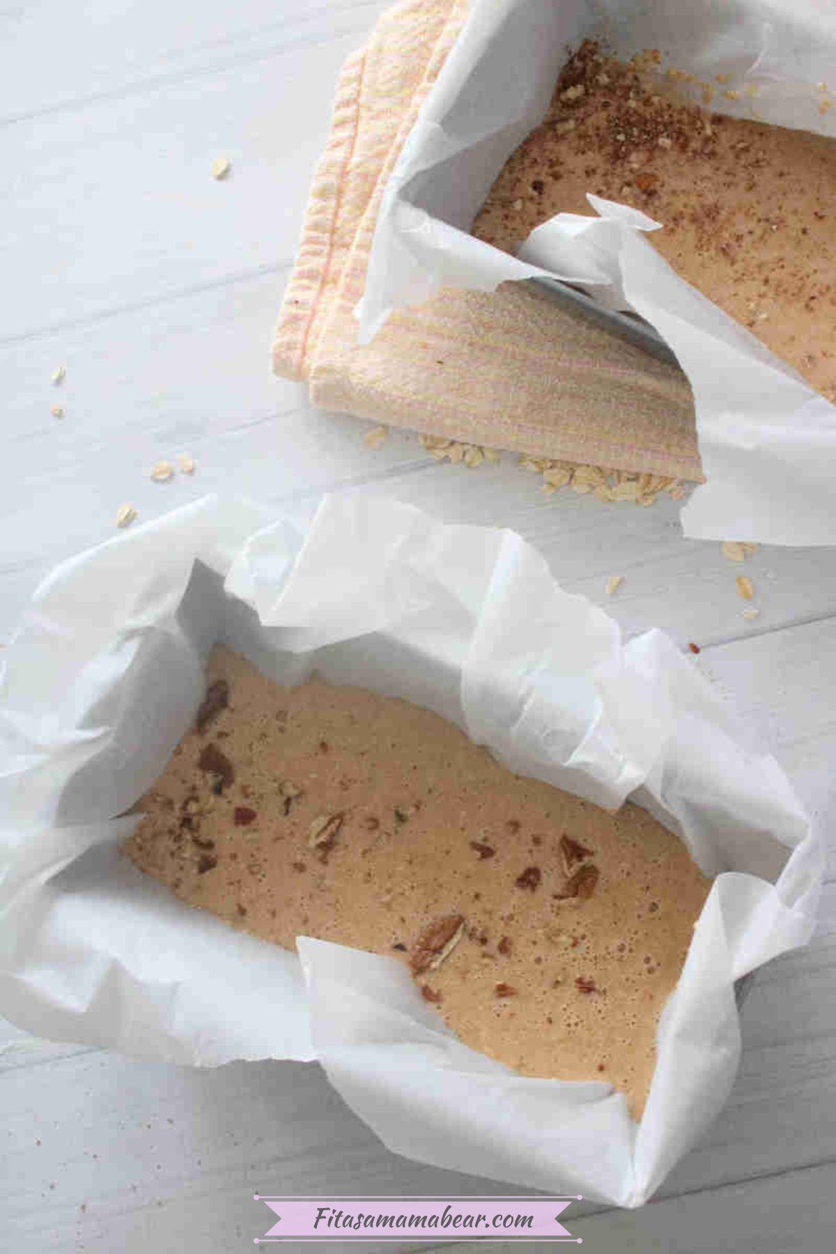 Two low calorie baked oats in a baking pan lined with parchment paper.