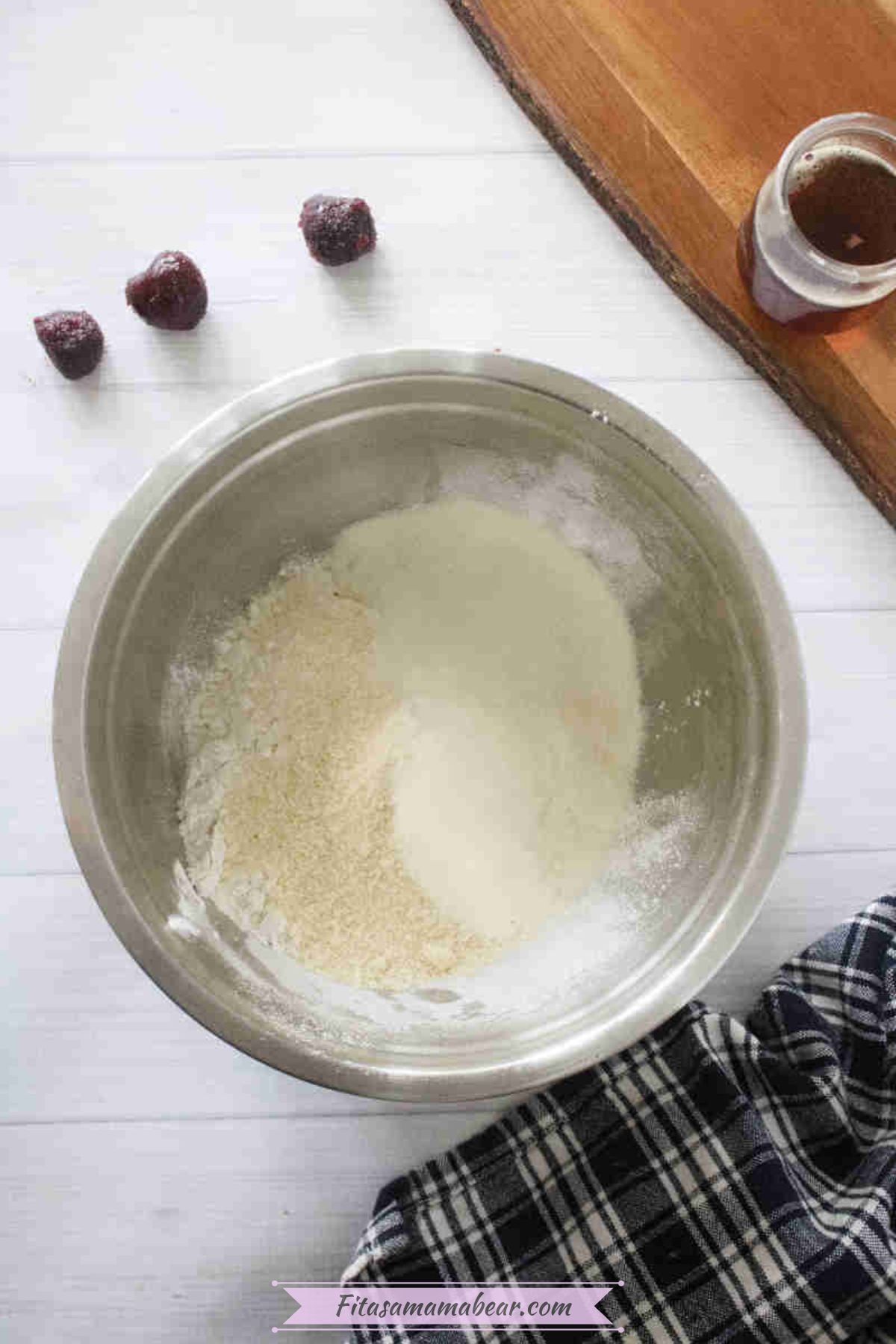 Steel bowl with almond flour, baking flour, and collagen pwoder in it.
