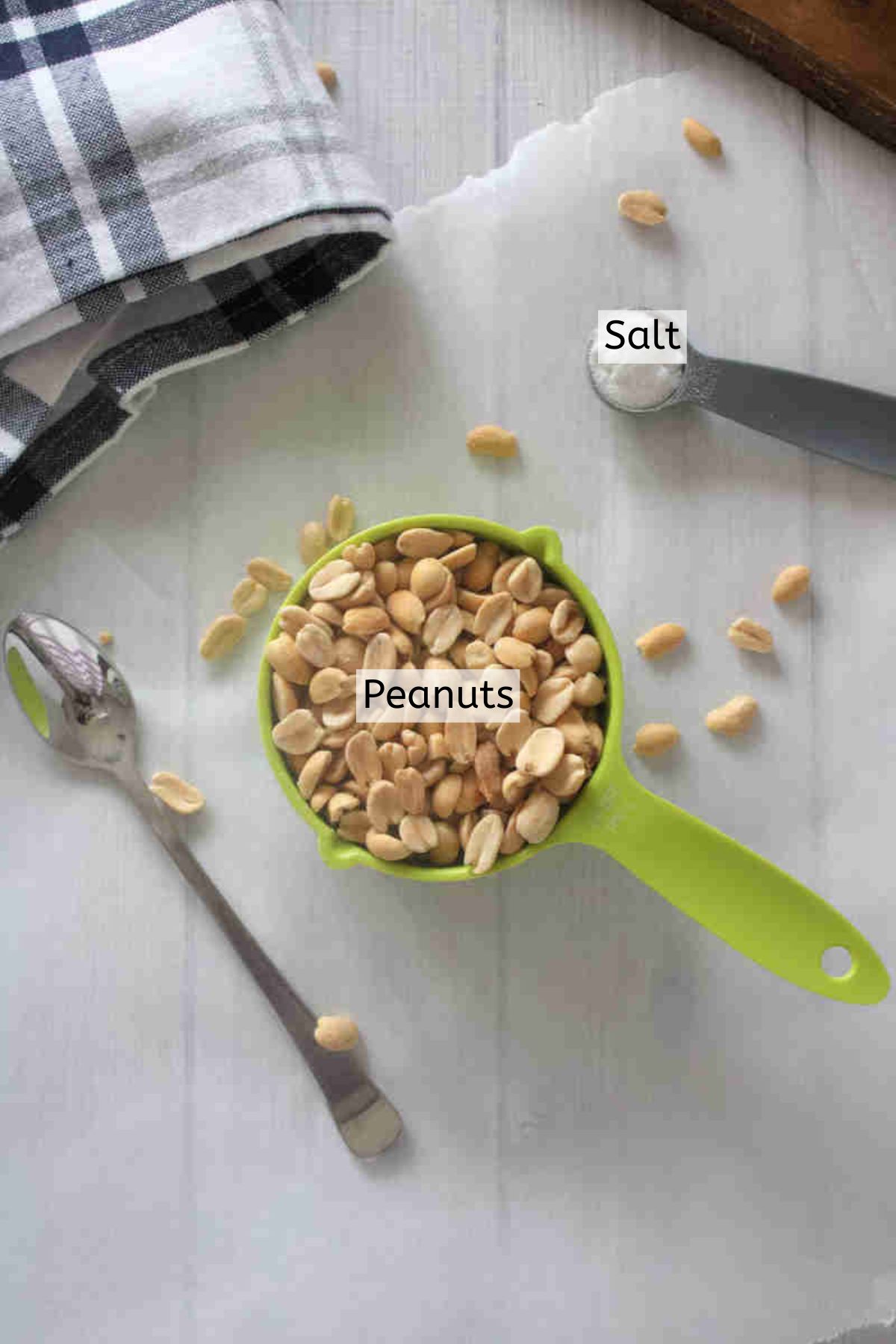 Peanuts and salt in measuring cups with text over top.