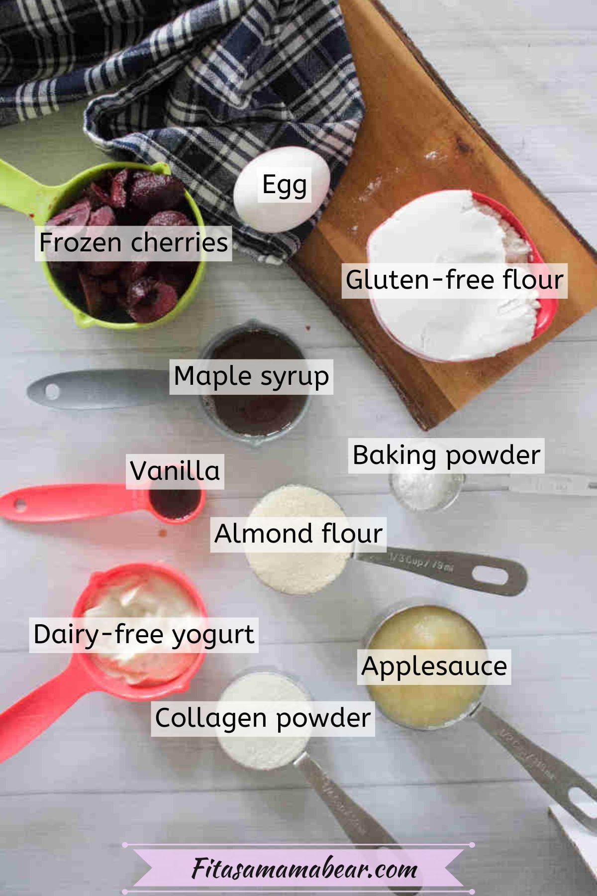 Ingredients to make cherry muffin tops like gluten-free flour, maple syrup, yogurt, all in measuring cups with text labels over top.
