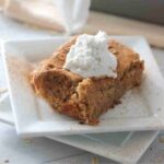 A plate of low calorie baked oats with coconut milk cream on top.