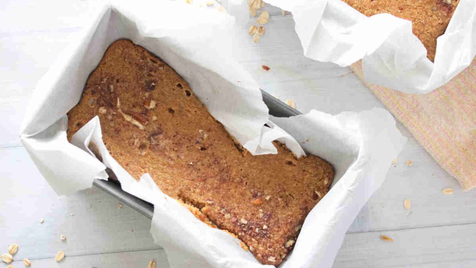 Low calorie baked oats in a baking pan lined with parchment paper.