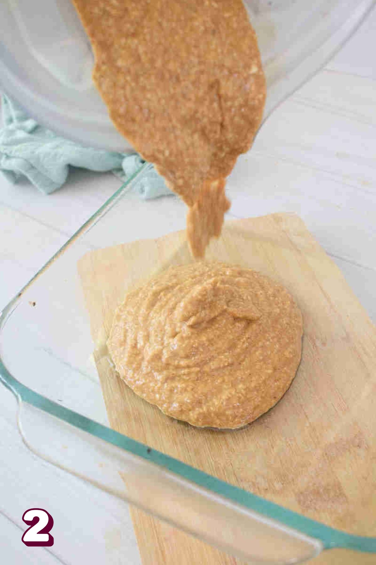 Blended pumpkin oat mixture being poured into a baking dish.