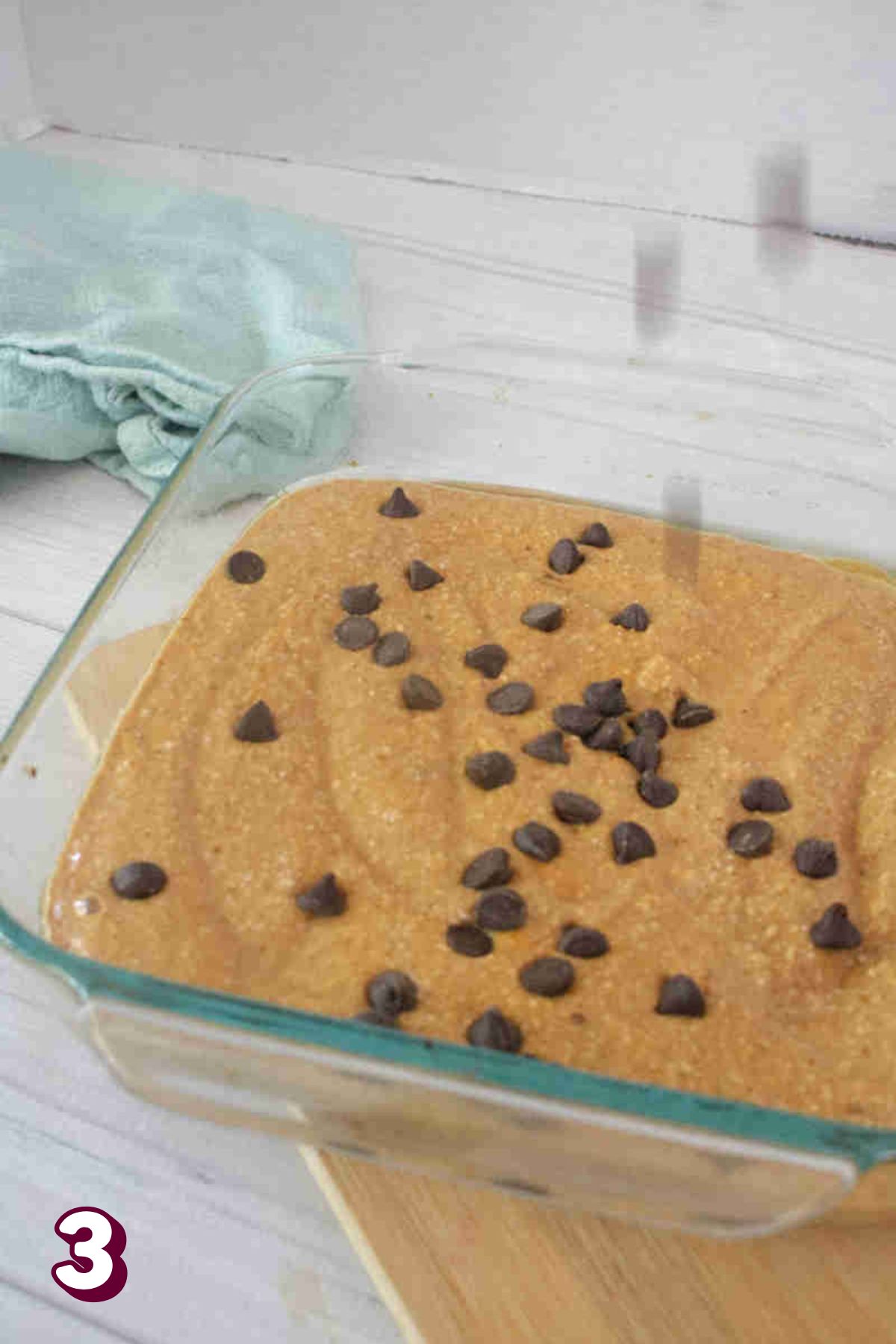 Pumpkin oat batter with chocolate chips placed in a baking dish.