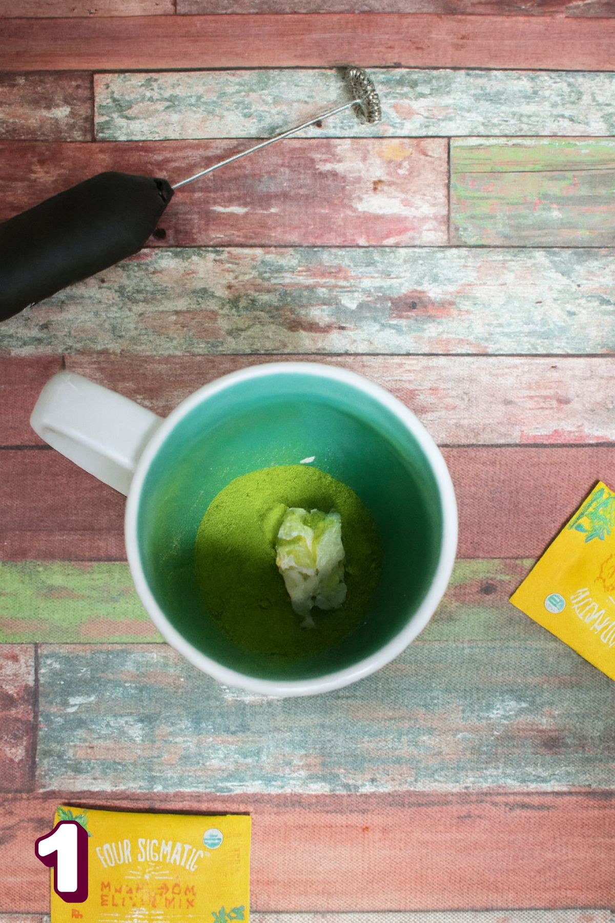 Coconut milk and matcha powder in a white mug.