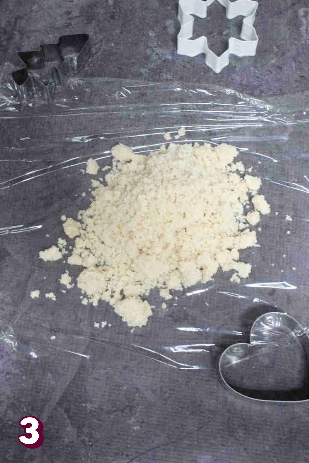 Almond flour cookie dough on plastic wrap.