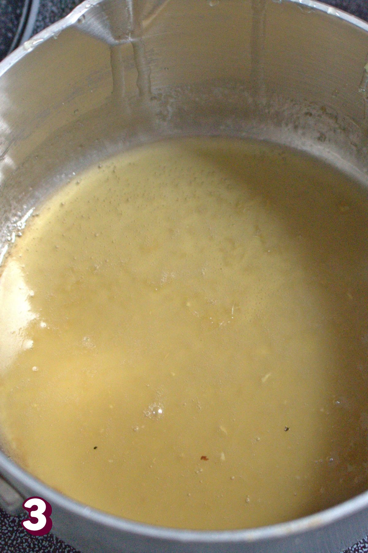 Melted honey, lemon and coconut oil in a small pot.