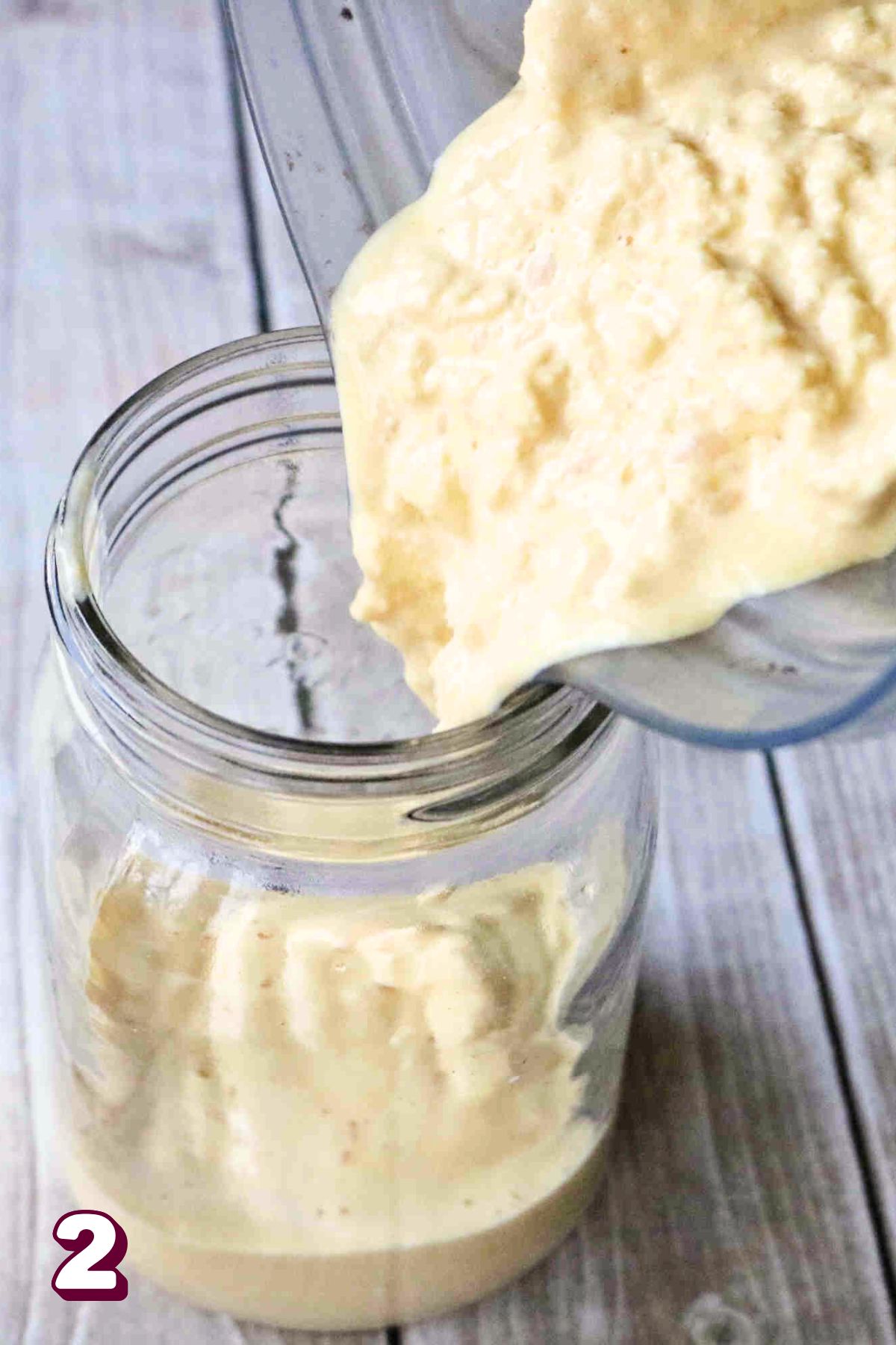 Turmeric protein shake being poured into a mason jar.