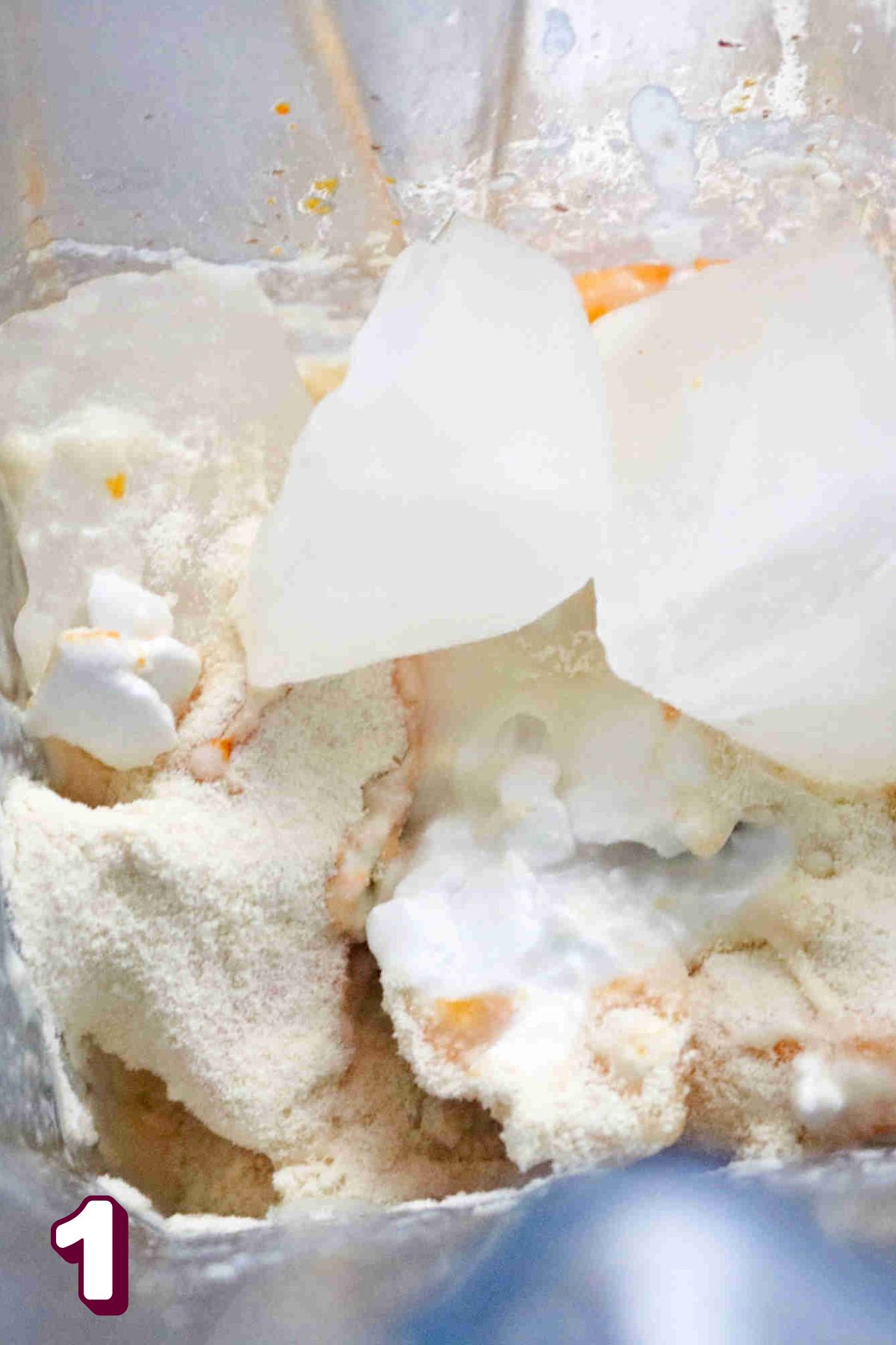 Ice, protein powder, and turmeric in a blender.