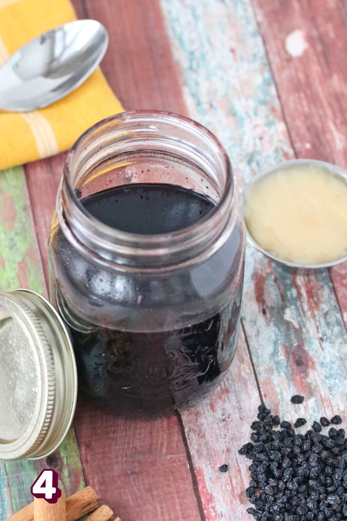 Homemade elderberry syrup in a mason jar.