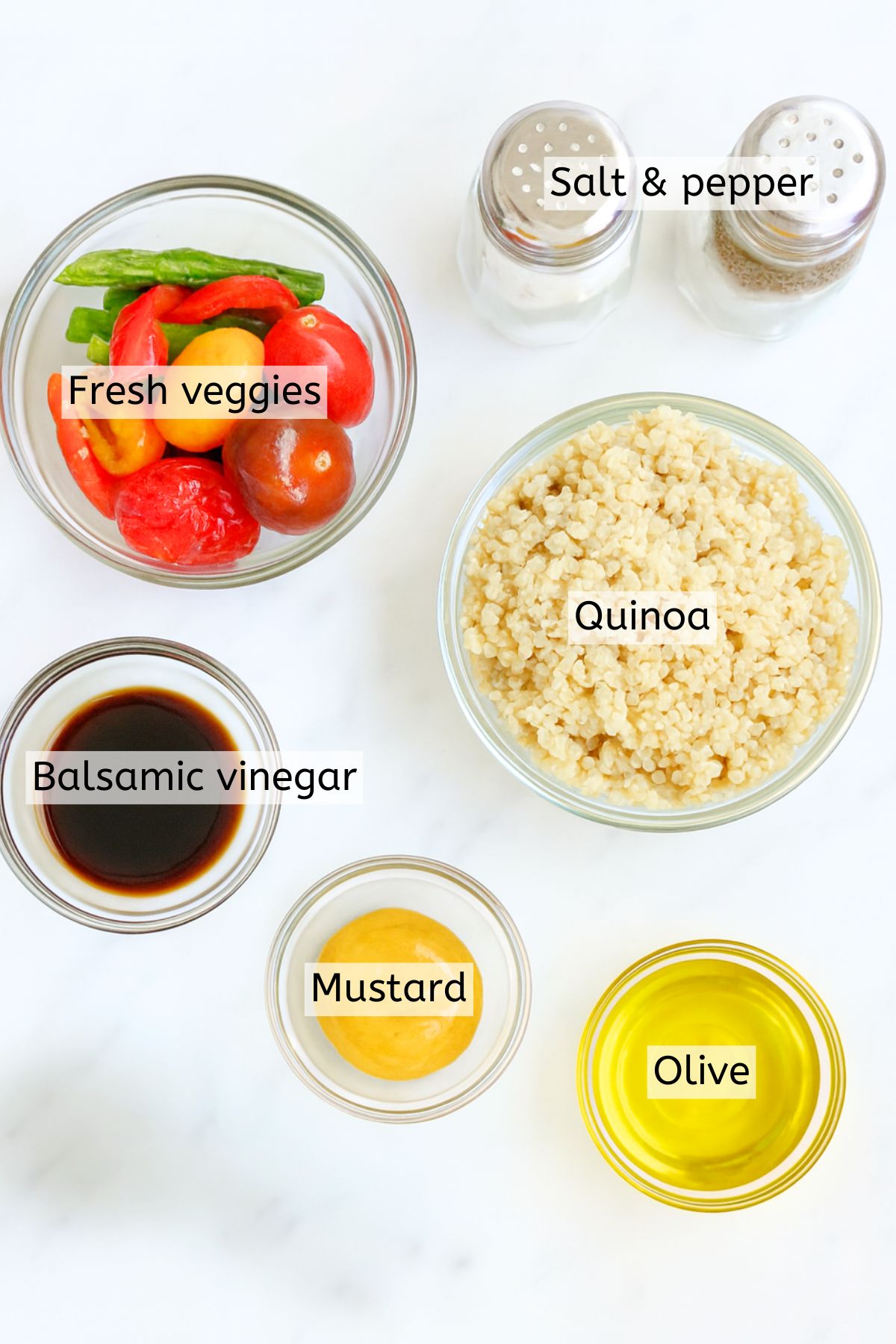 Quinoa, veggies, mustard, and dressings in glass bowls with text labels over top.