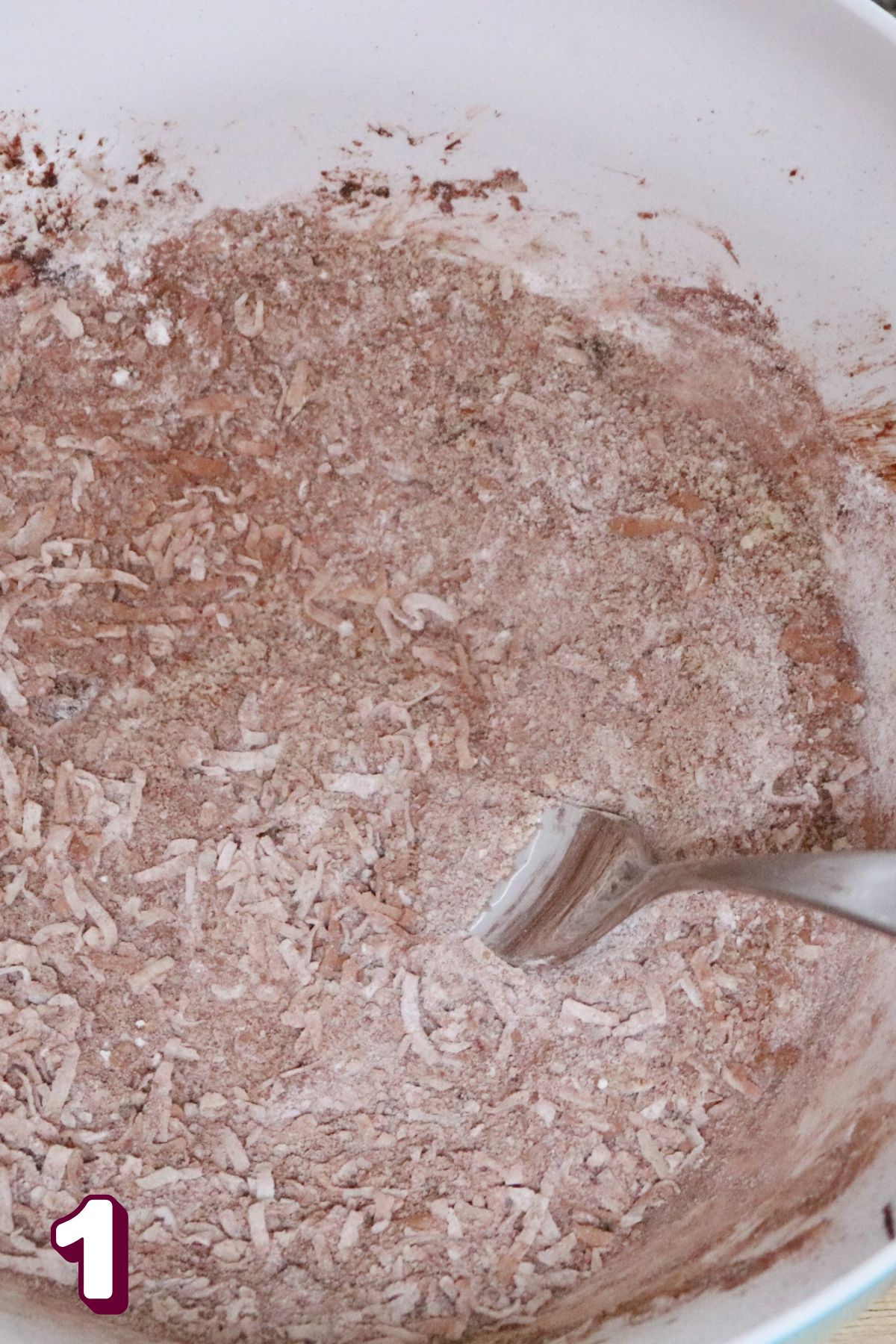 Mixing bowl with coconut, almond flour, and chocolate powder.