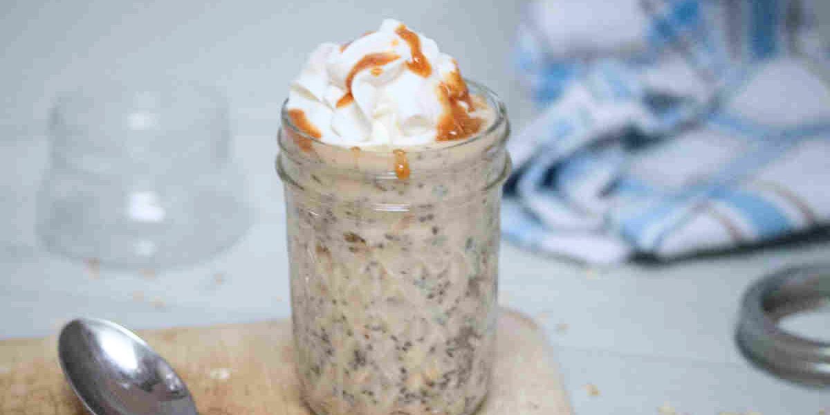 Mason jar with overnight protein powder oats topped with whipped cream and sauce.