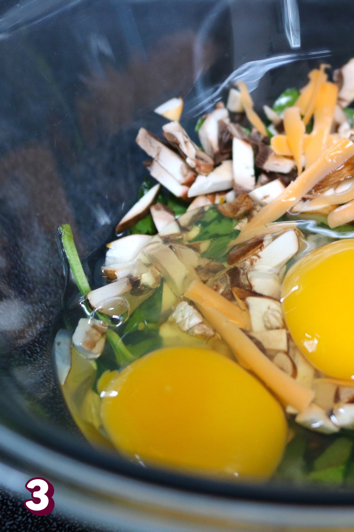 Eggs, mushrooms, spinach, and cheese in a cast-iron skillet.