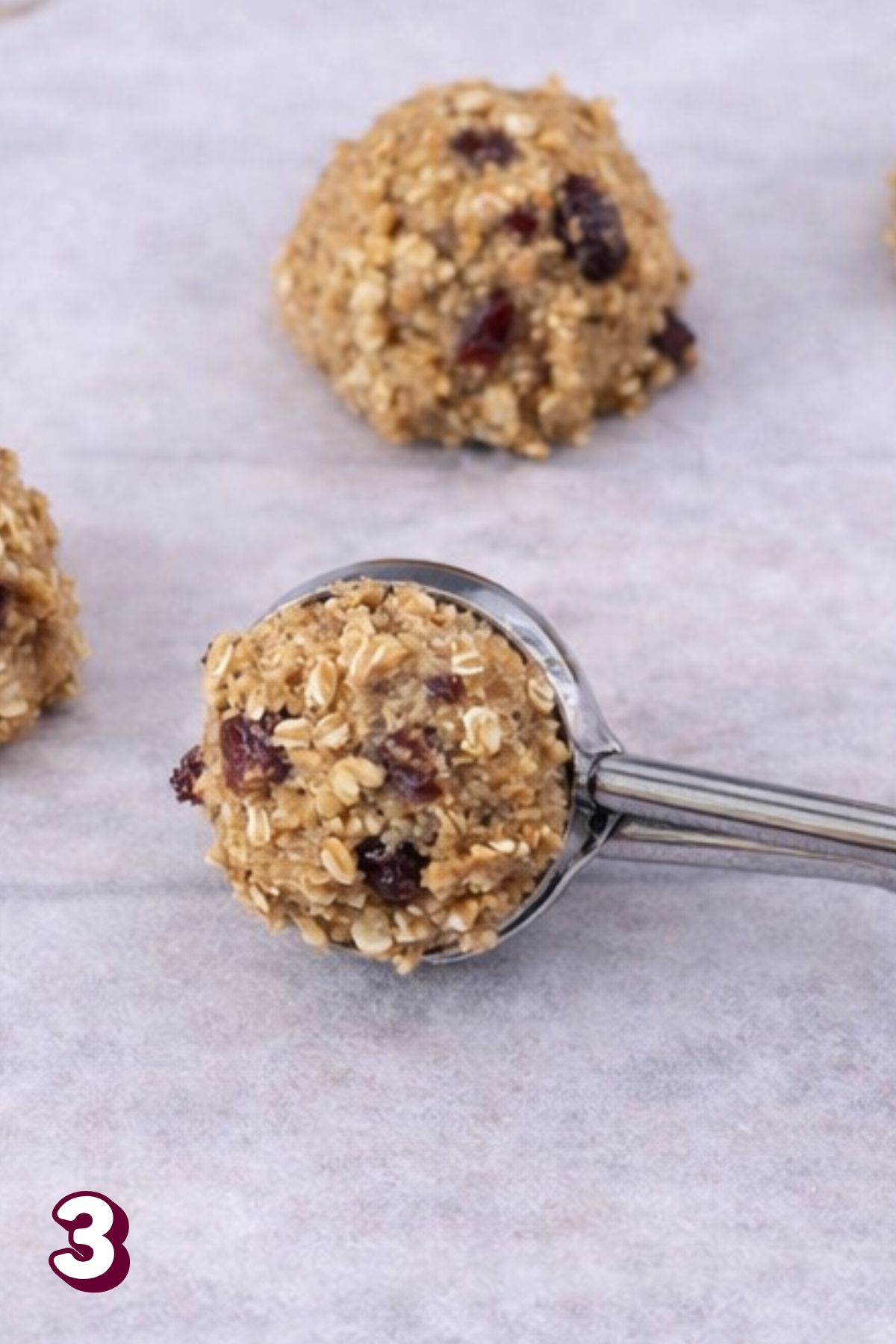 No bake lactation cookies being placed on parchment paper.