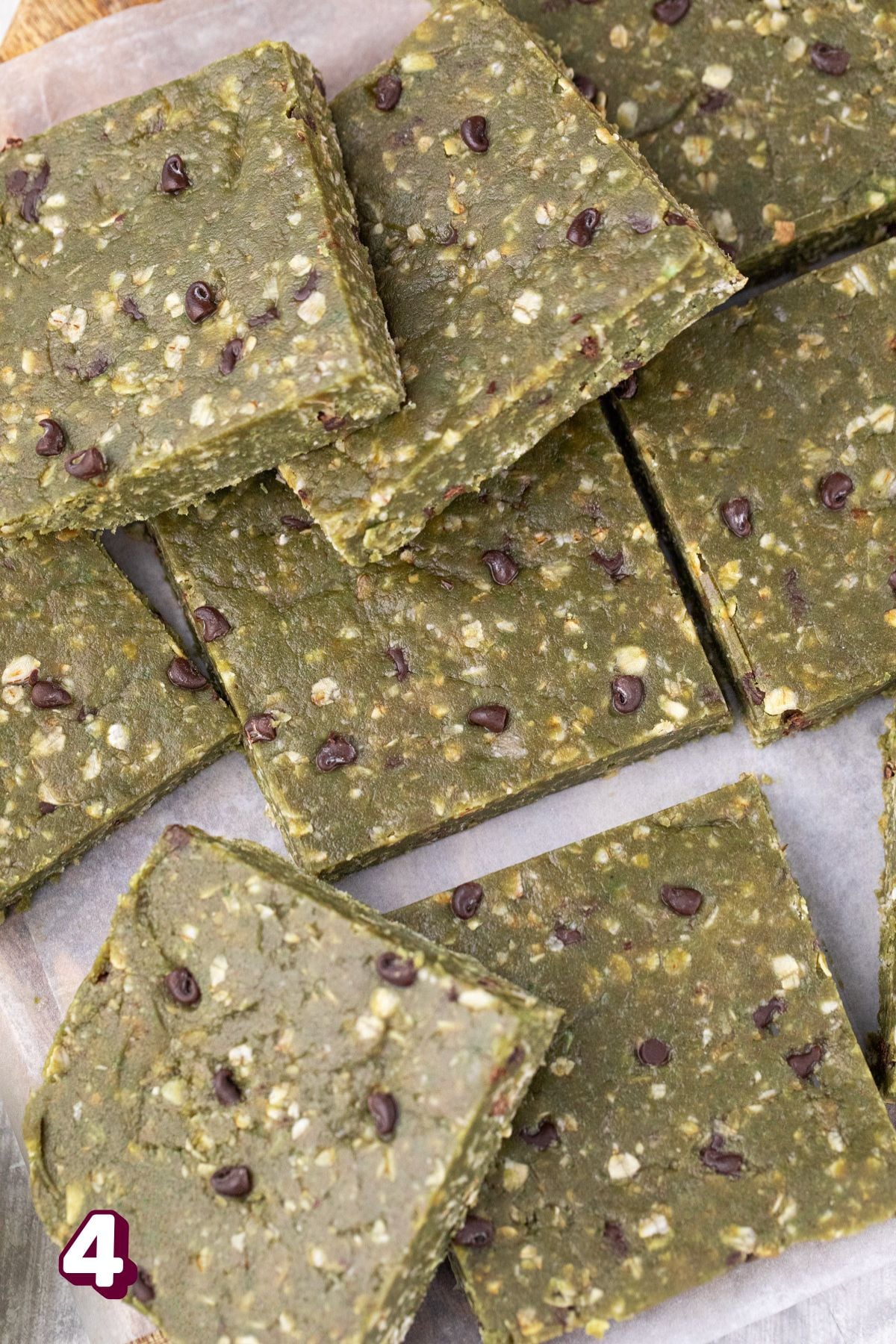 Green matcha protein bars cut in squares all on top of each other.