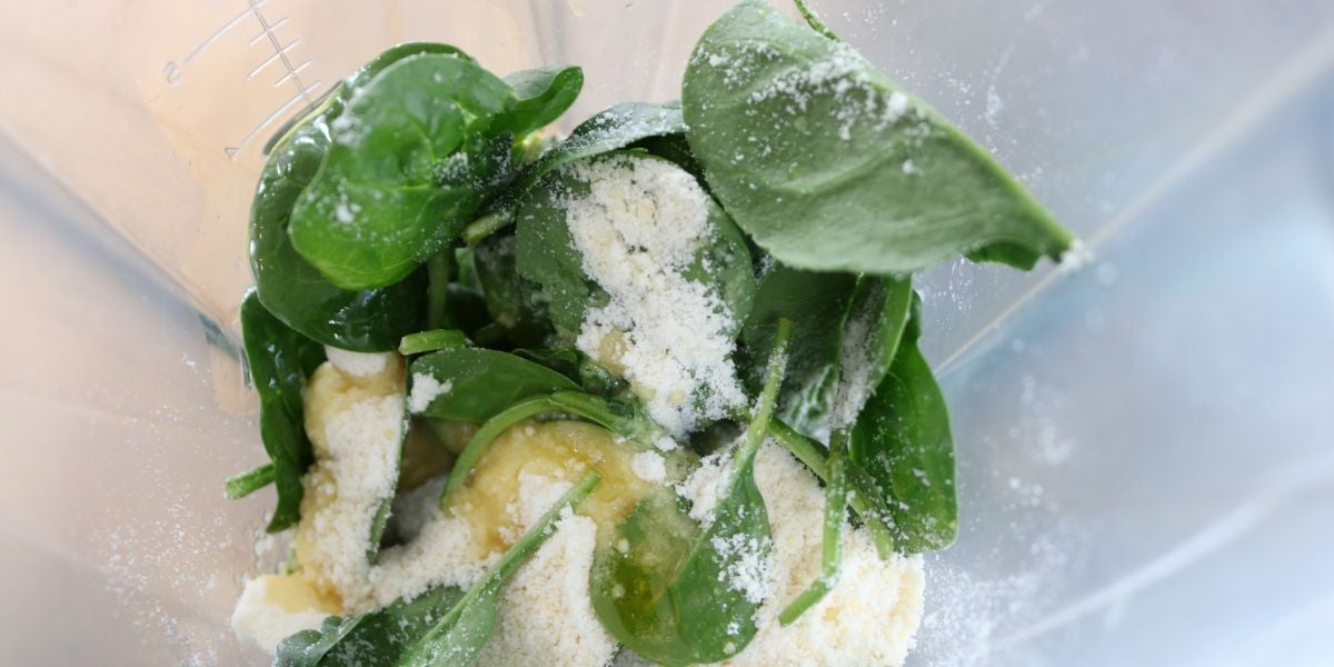 Spinach and vegan parm in a food processor.