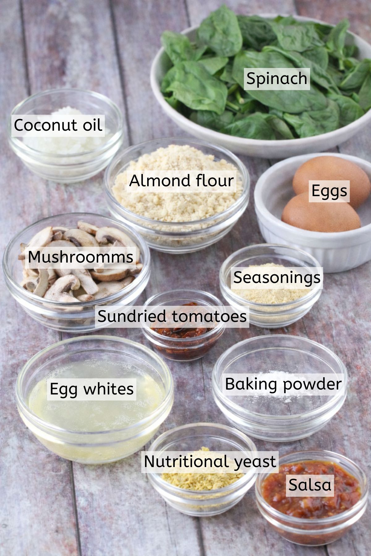 Ingredients for quiche cups in glass bowls with text labels over top.