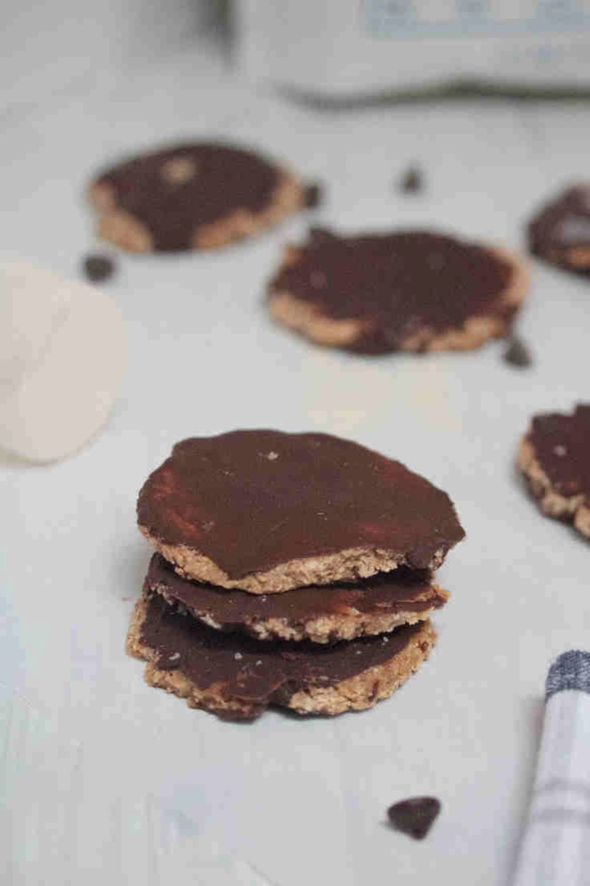 Three protein thin mint cookies covered in chocolate stacked.