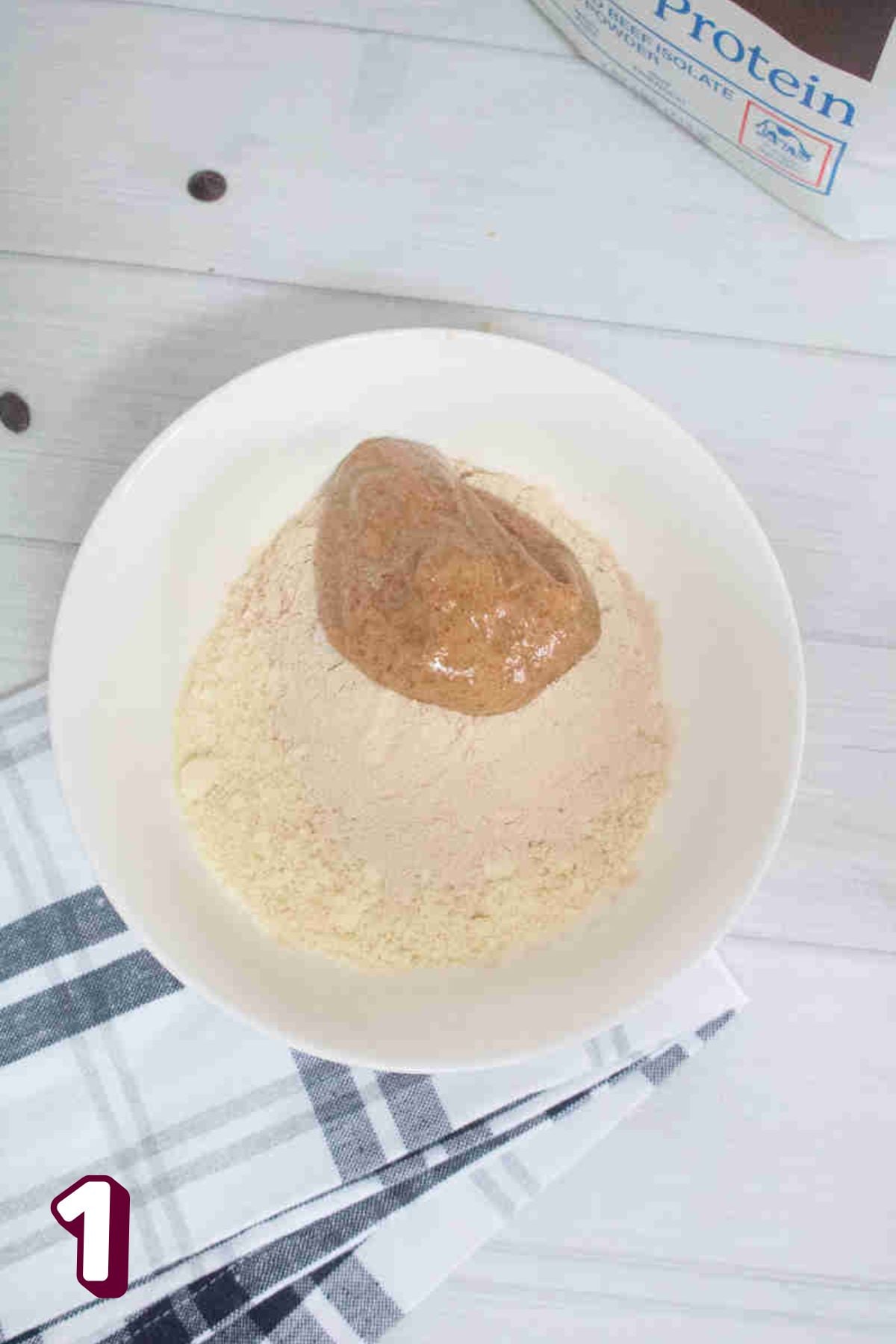Almond butter and protein powder in a white bowl.