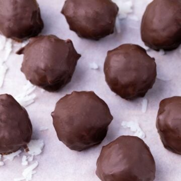 Chocolate coated protein balls on parchment paper.