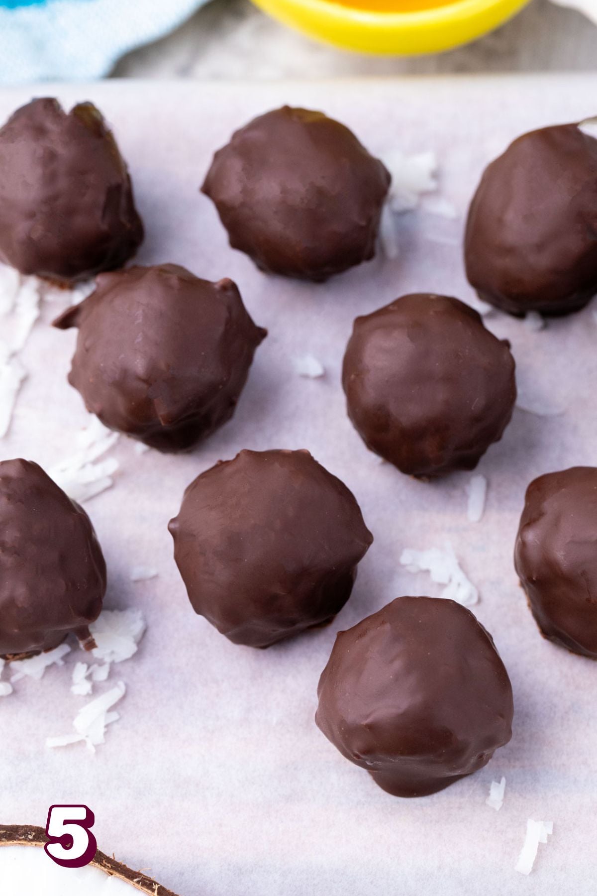 Chocolate coated protein balls on parchment paper.