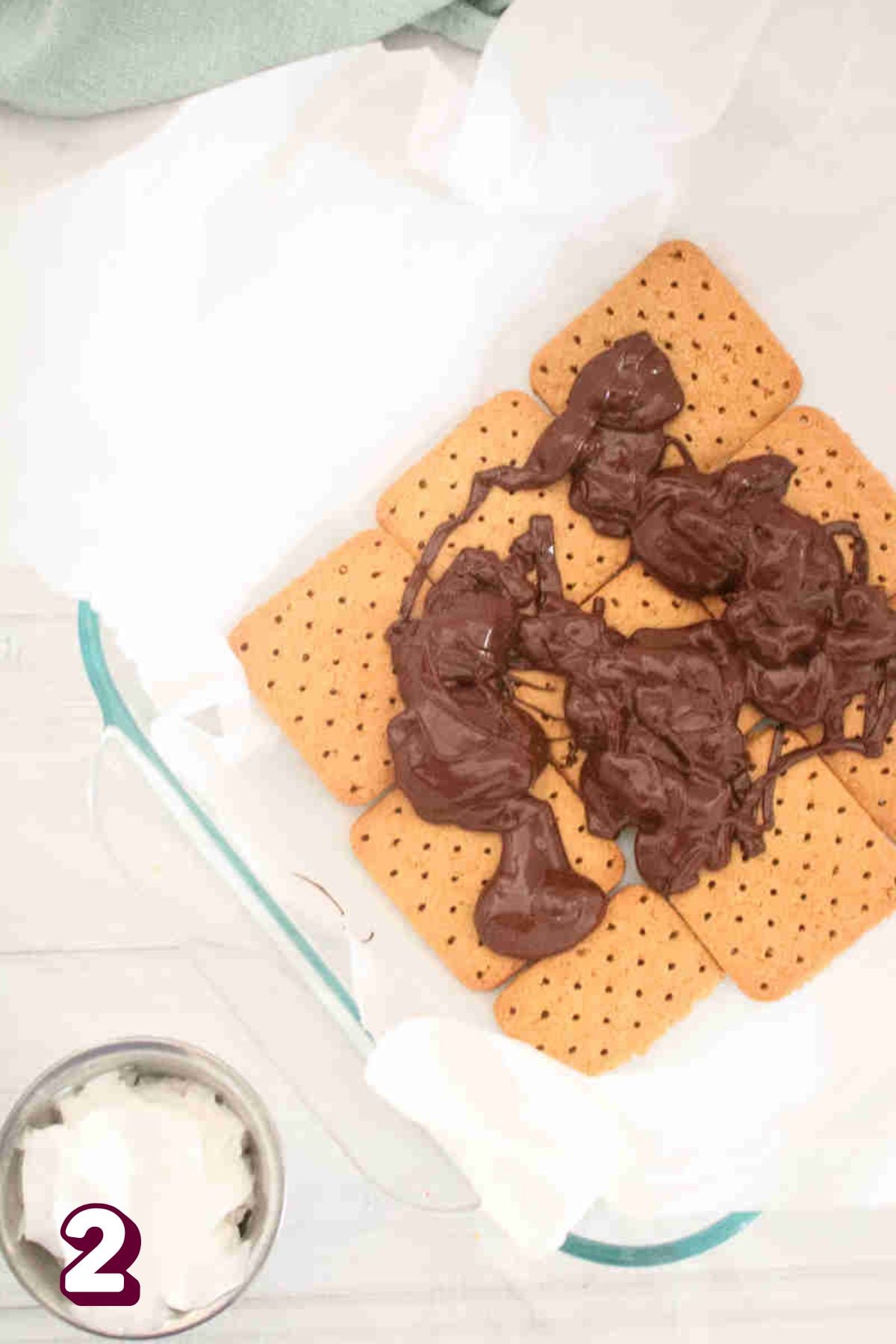 melted chocolate on top of layered graham crackers