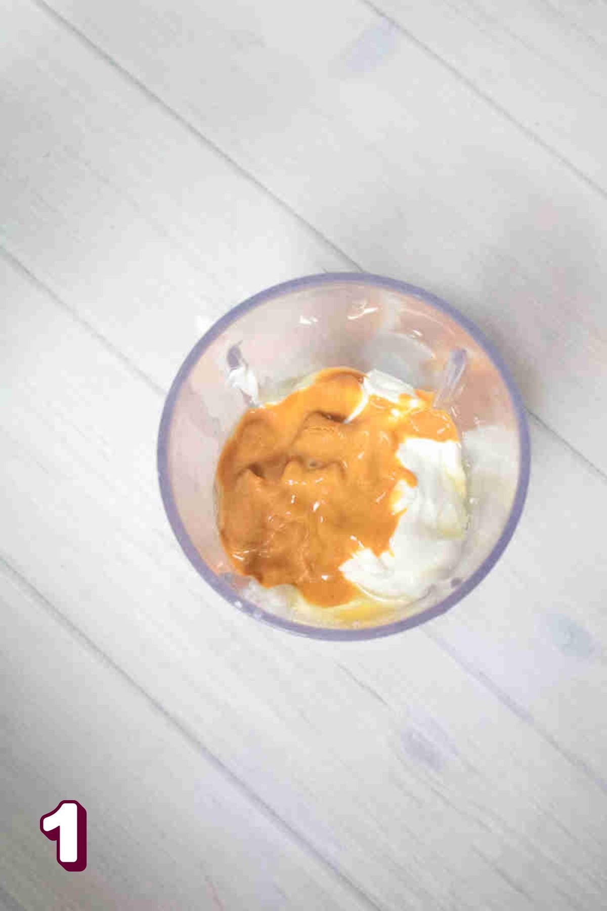 Blender with peanut butter, yogurt, and eggs.